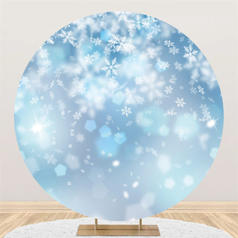 Toile de fond ronde de joyeux noël bleu scintillant de neige blanche